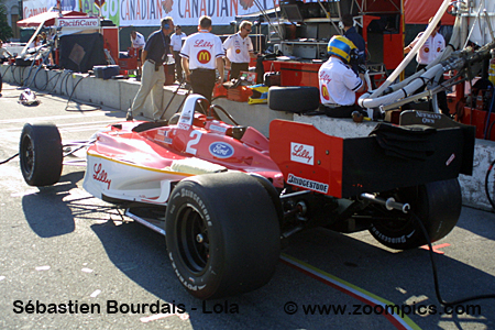 Bruno Junqueira, of Belo Horizonte, Brazil, guides his Ford-Cosworth Lola  for Neman/Haas Racing through the nine turn of the course of the Grand Prix  of Denver with other racers behind him on