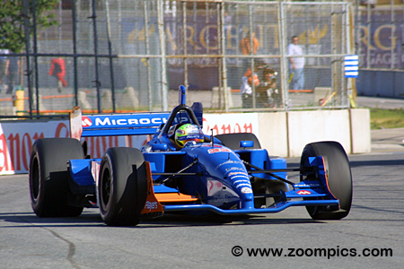 Bruno Junqueira, of Belo Horizonte, Brazil, guides his Ford-Cosworth Lola  for Neman/Haas Racing through the nine turn of the course of the Grand Prix  of Denver with other racers behind him on